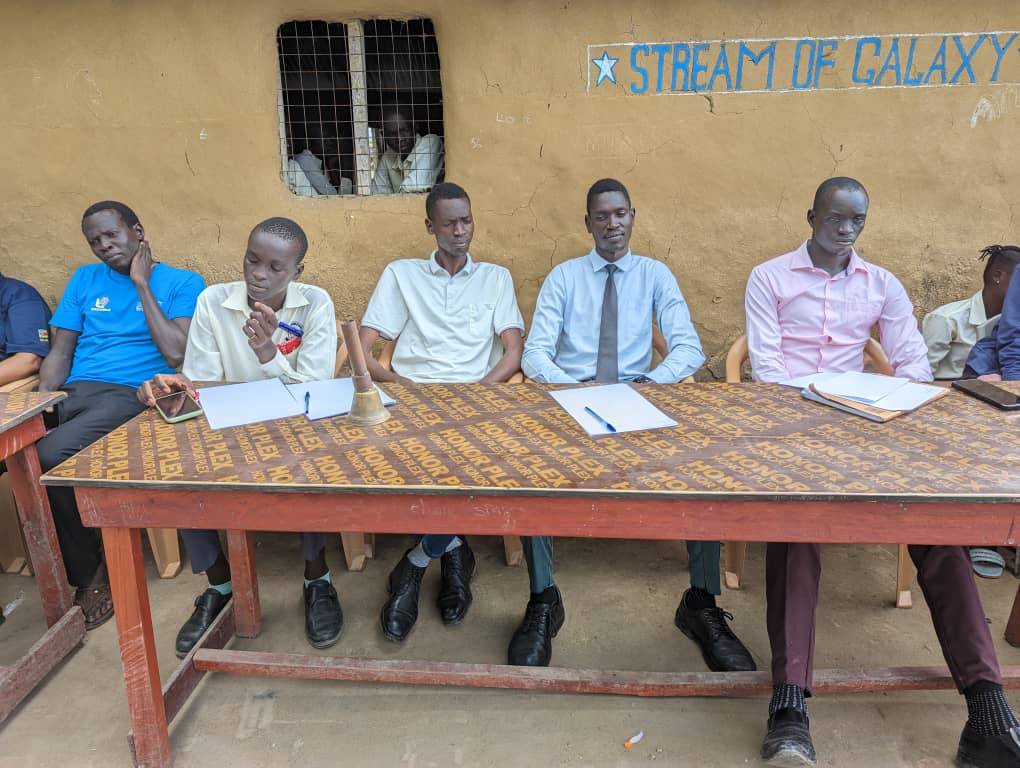 School leaders and staff seated during a meeting at Saint Andrews